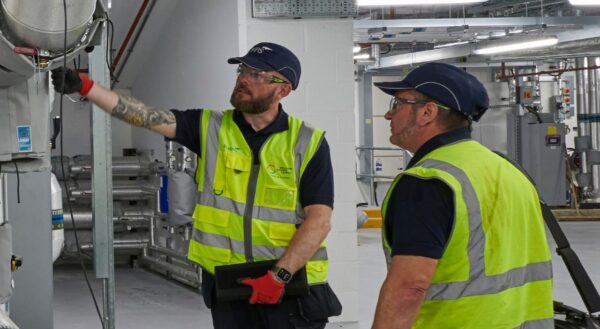 Two Wates workers conducting facilities management tasks