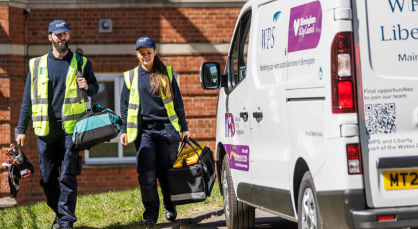Two WPS operatives walking by a van
