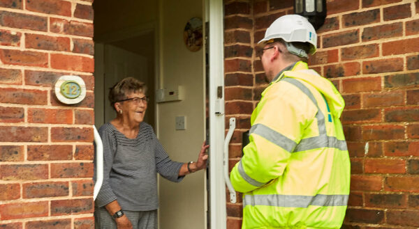 An operate and a resident speak at the door